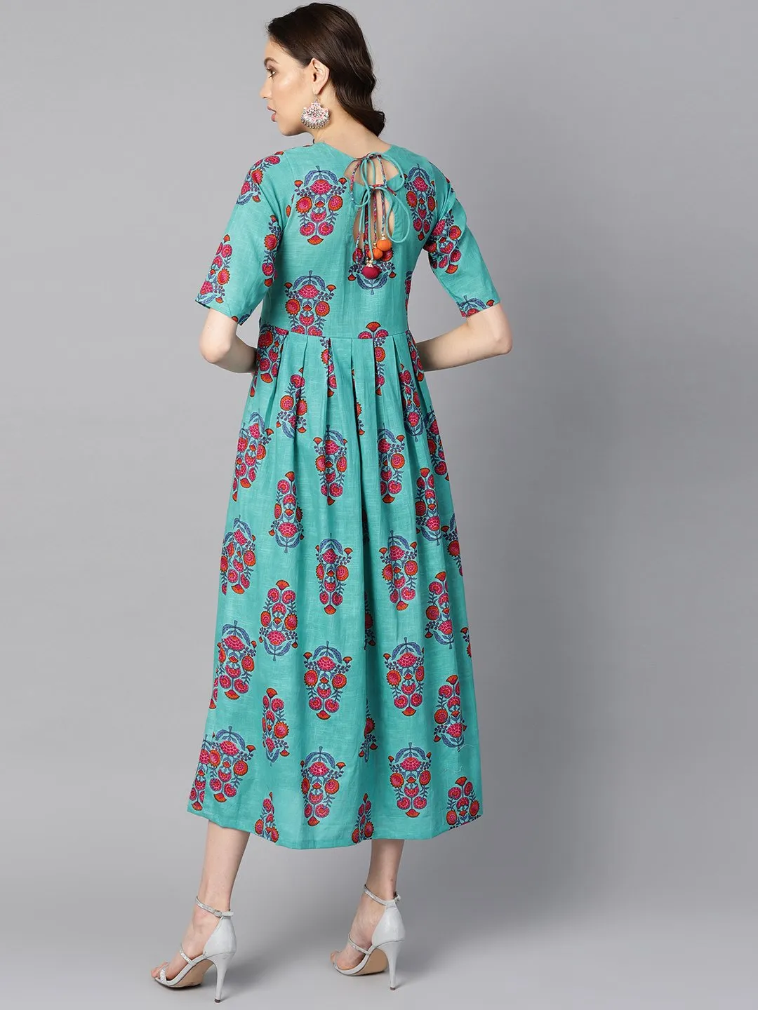 Turqish Blue Color Printed Half Sleeve Pleated Maxi Dress With Deep Back And Tassel Detailing.